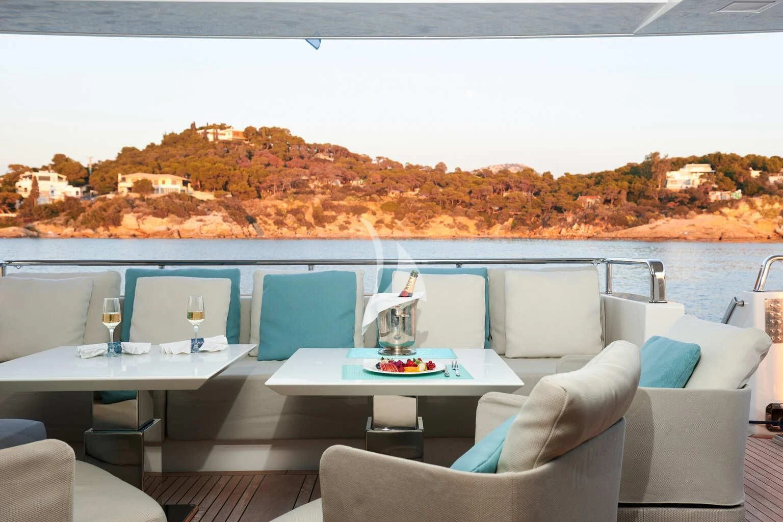 a table with chairs and a view of a city aboard DE ZEUS Yacht for Sale