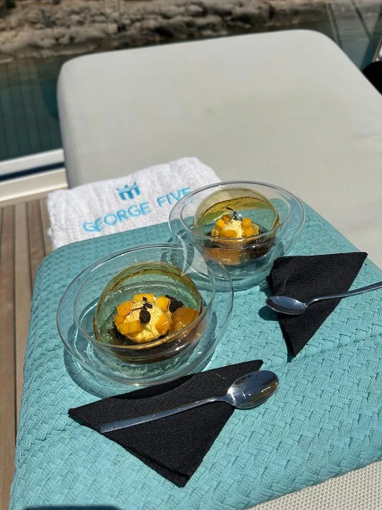 a bowl of fruit and a bowl of yogurt on a table aboard DE ZEUS Yacht for Sale