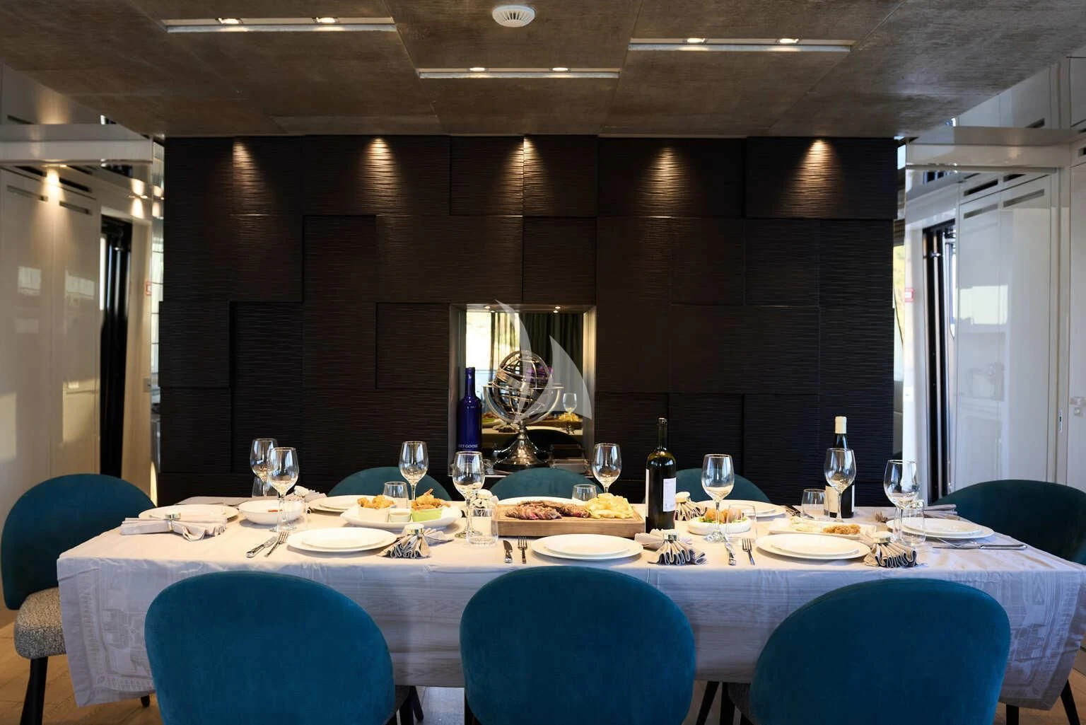 a dining room with a table set for a dinner aboard DE ZEUS Yacht for Sale