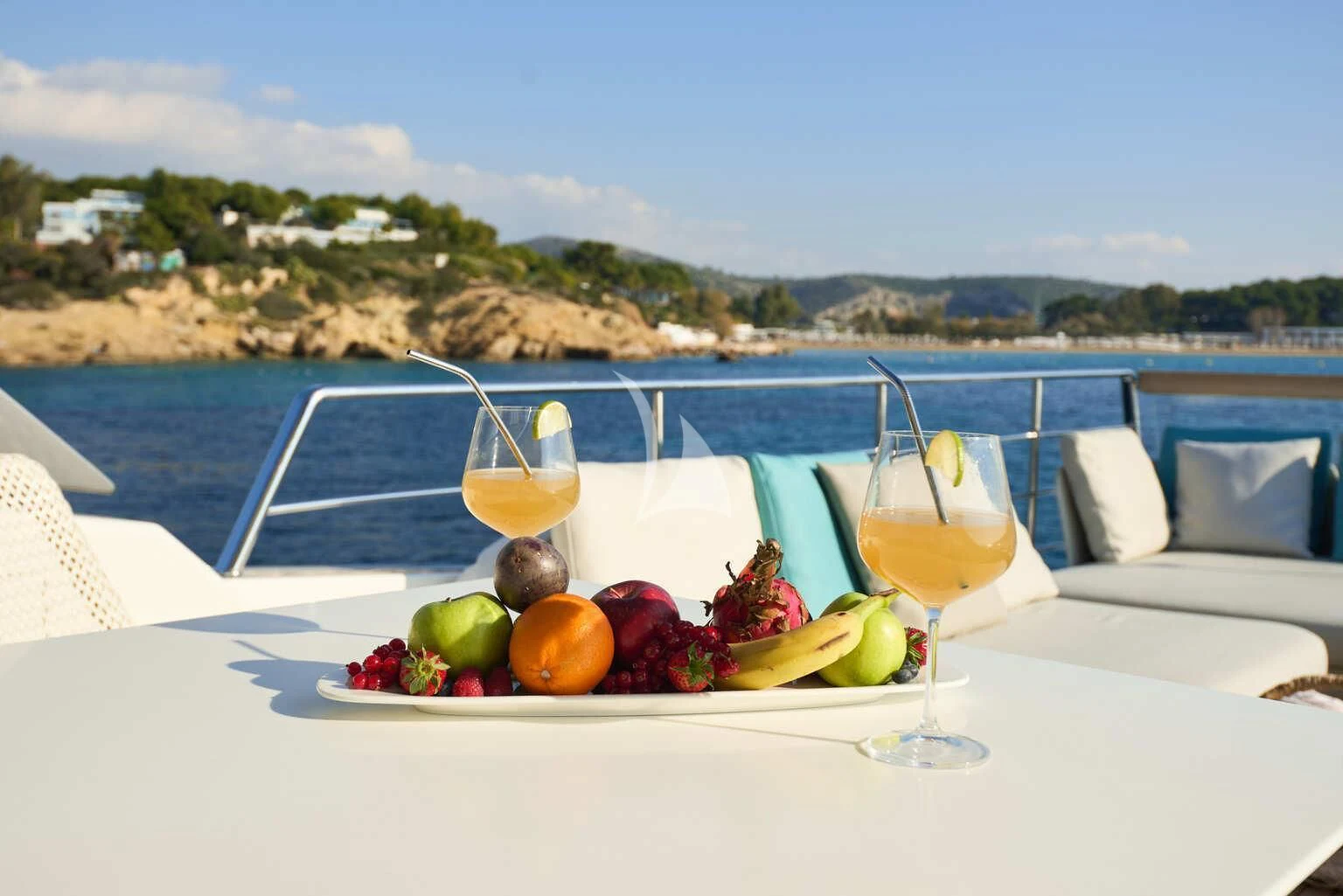 a table with a glass of wine and fruits on it aboard DE ZEUS Yacht for Sale