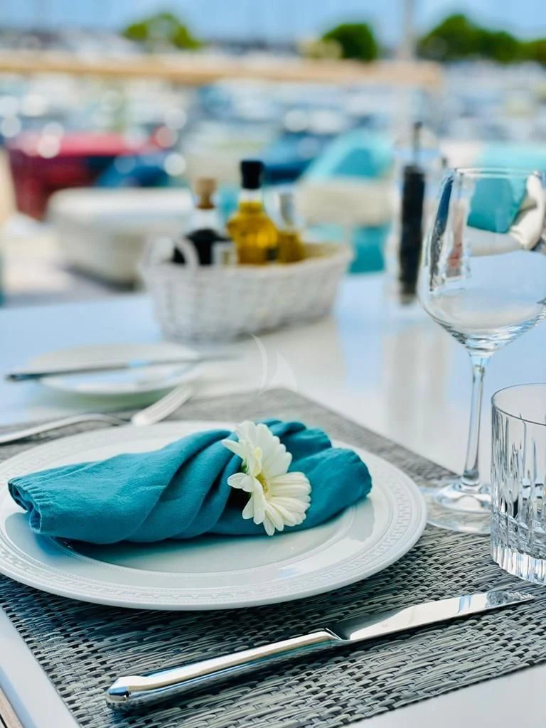 a plate with a napkin and fork on it aboard DE ZEUS Yacht for Sale