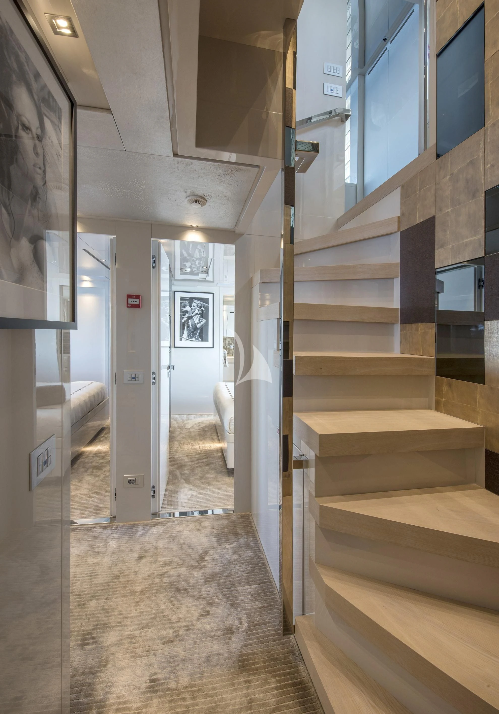 a long hallway with a white bed and a white chair aboard DE ZEUS Yacht for Sale