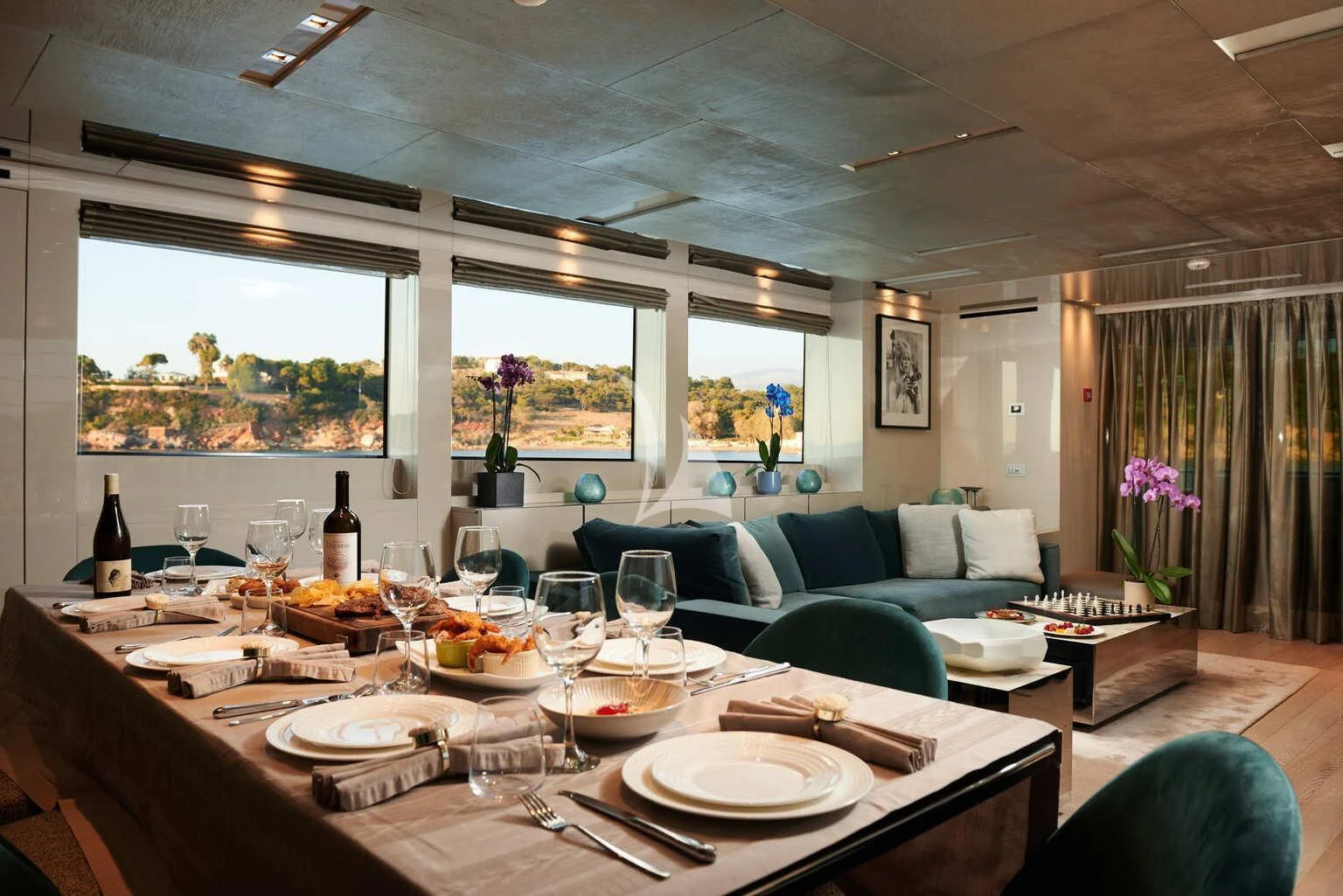 a dining table with plates and glasses aboard DE ZEUS Yacht for Sale