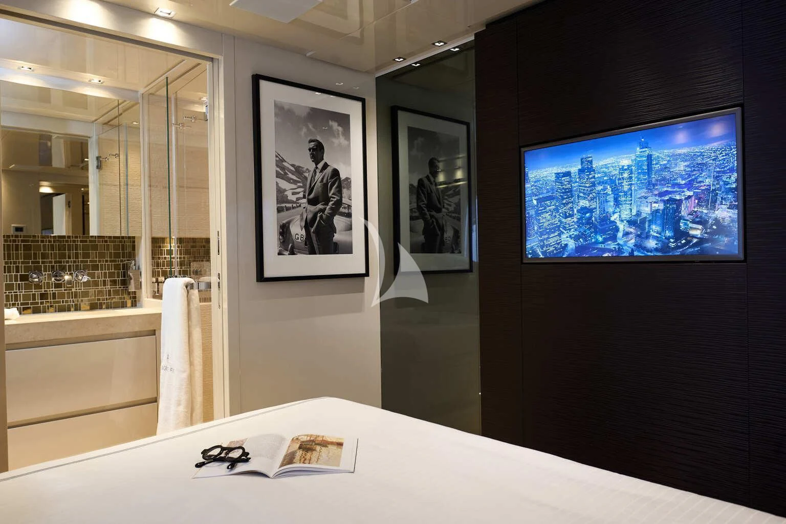 a room with a tv and pictures on the wall aboard DE ZEUS Yacht for Sale