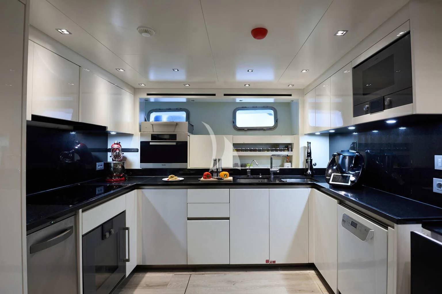 a kitchen with white cabinets aboard DE ZEUS Yacht for Sale