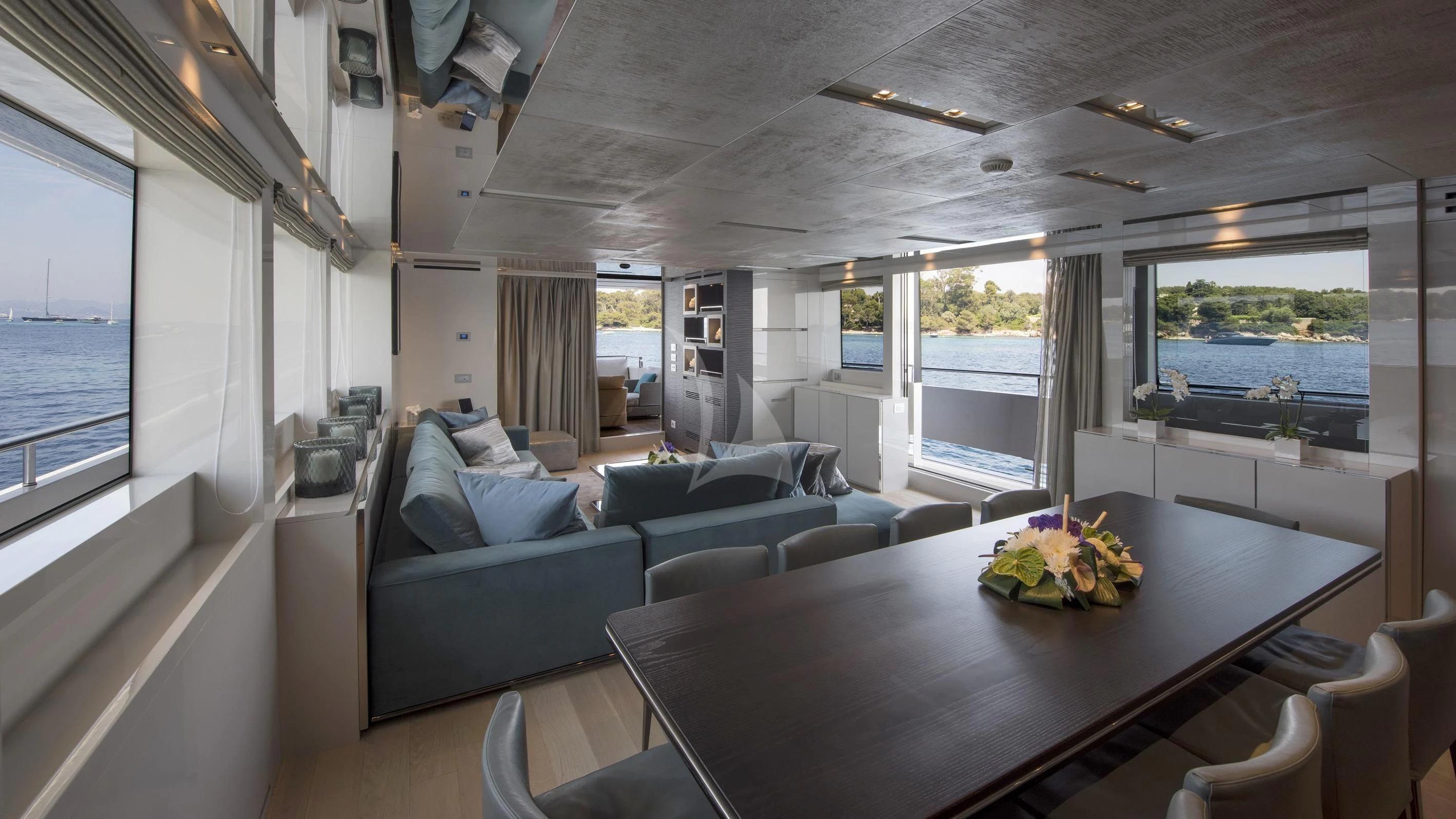 a living room with a table and couches aboard DE ZEUS Yacht for Sale