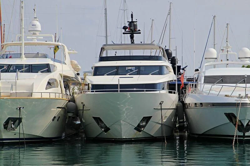 several white boats in a harbor aboard DE ZEUS Yacht for Sale