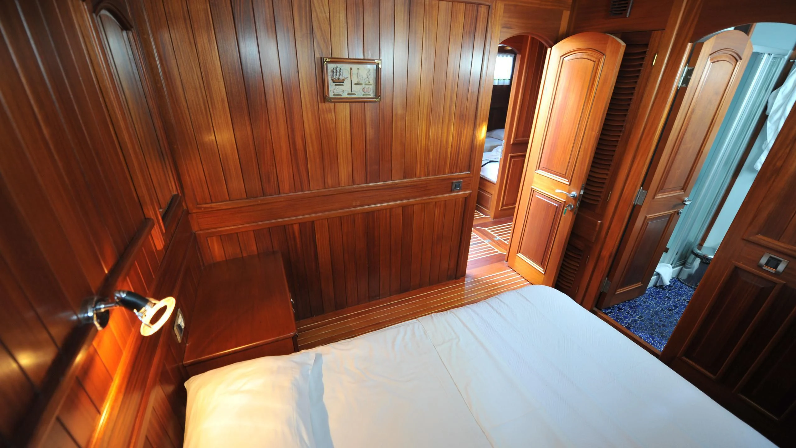 a room with wooden walls and a bed aboard CARPE DIEM 1 Yacht for Sale