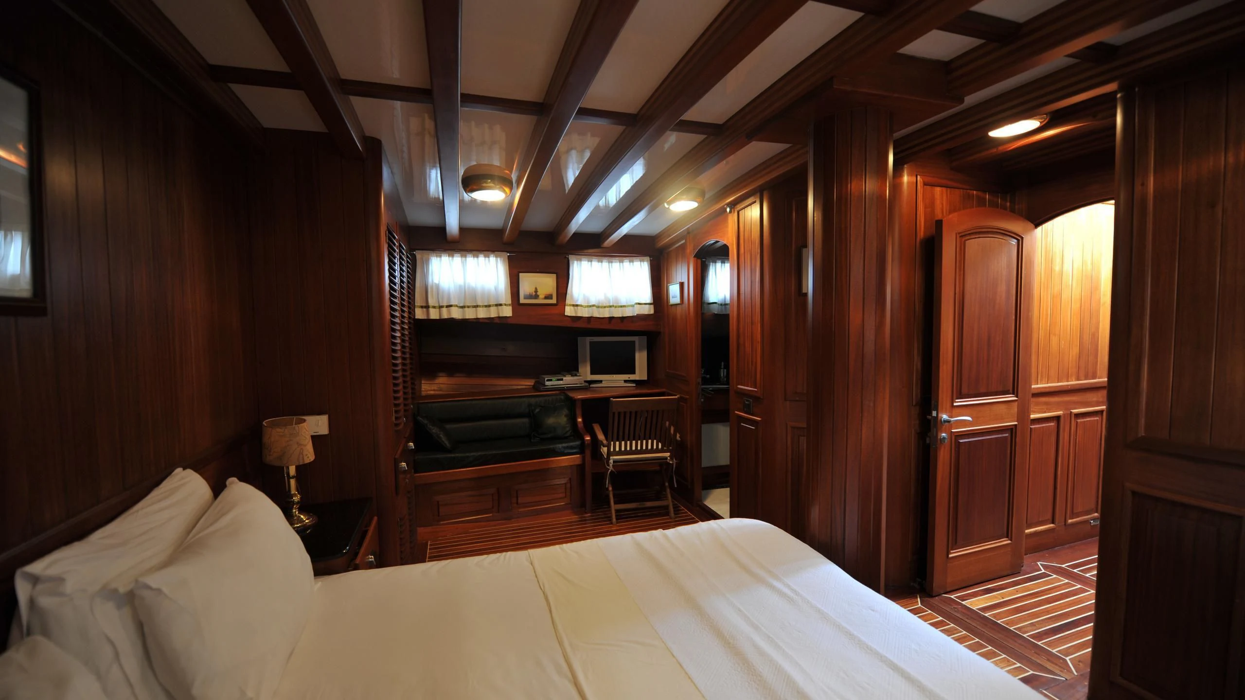 a room with a bed and piano aboard CARPE DIEM 1 Yacht for Sale