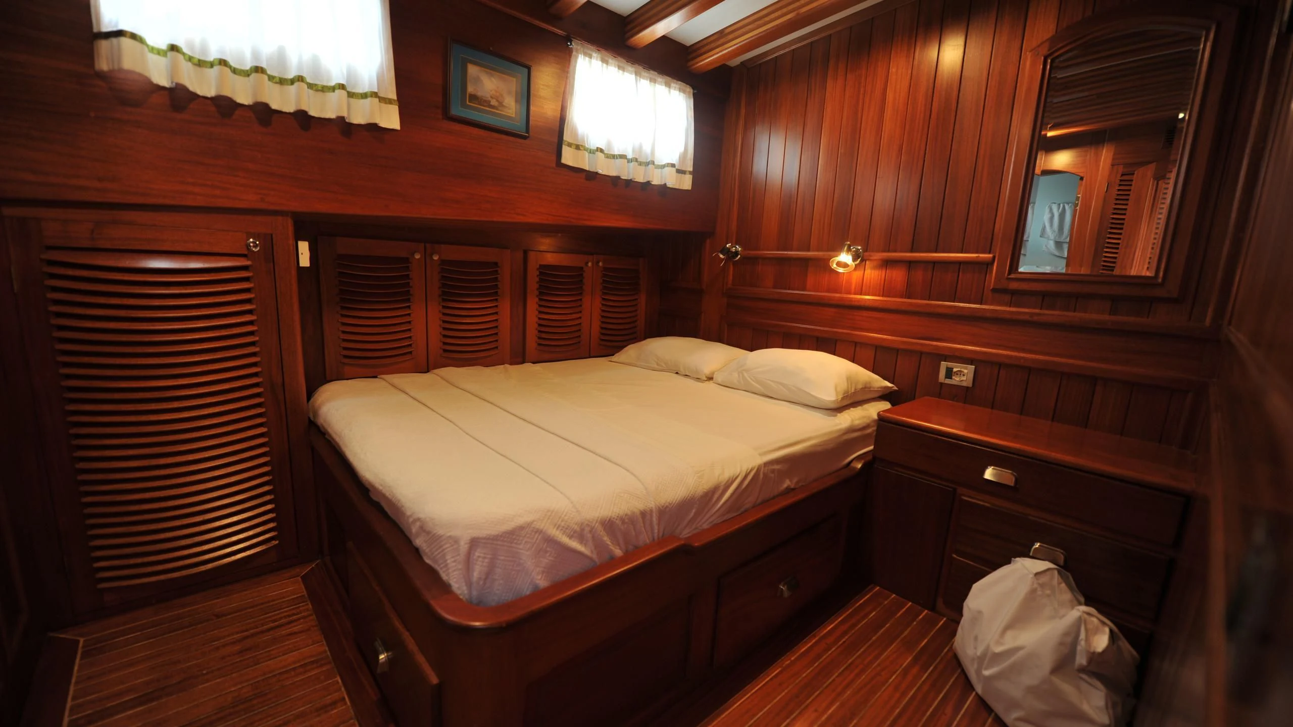 a room with a bed and a dresser aboard CARPE DIEM 1 Yacht for Sale