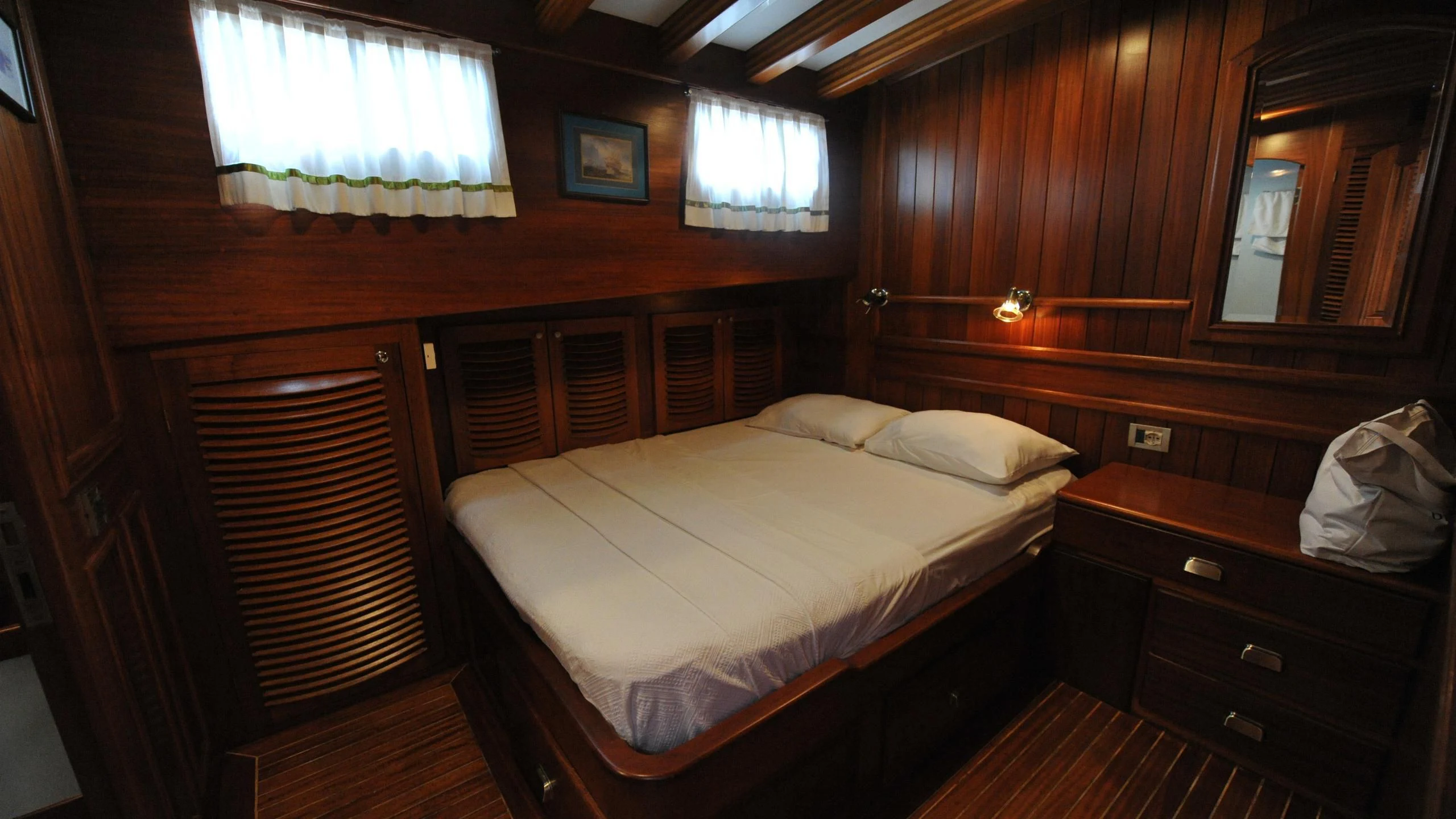 a room with a bed and a window aboard CARPE DIEM 1 Yacht for Sale