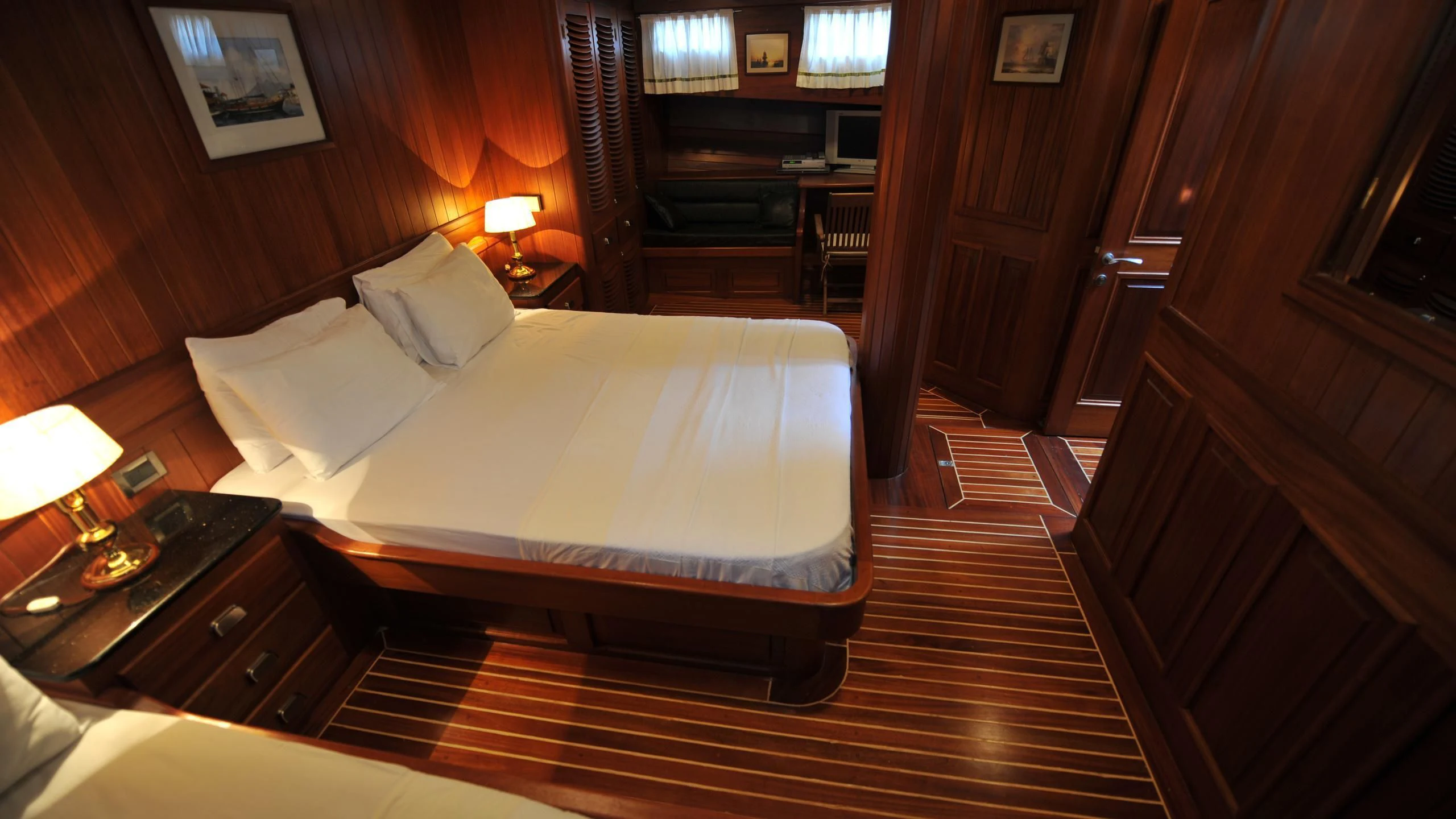 a room with a bed and a desk aboard CARPE DIEM 1 Yacht for Sale