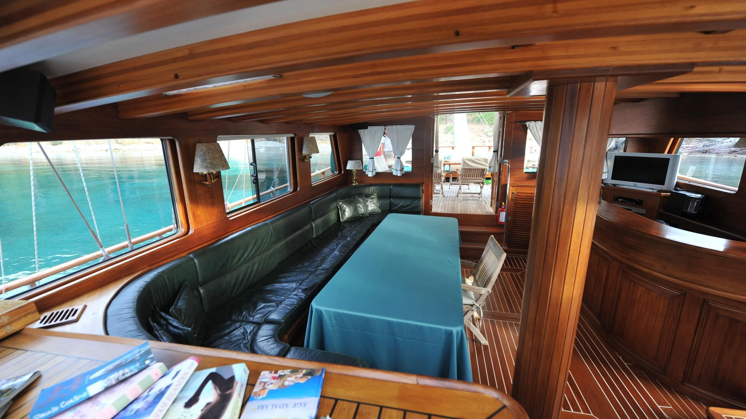 a room with a couch and a table aboard CARPE DIEM 1 Yacht for Sale