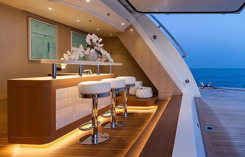 a room with a table and stools and a window aboard NENINKA Yacht for Sale
