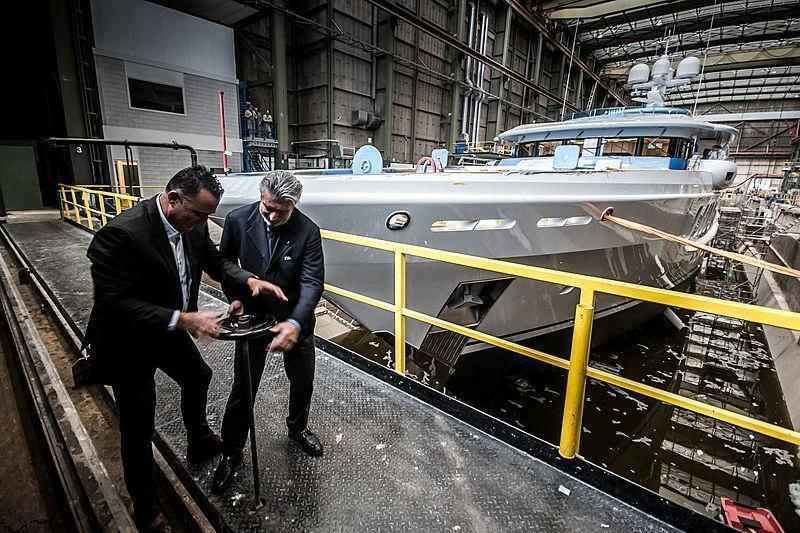 men in suits looking at a model train aboard NENINKA Yacht for Sale