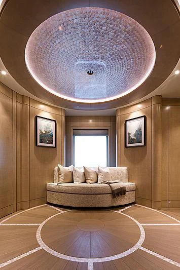 a large room with a round mirror aboard NENINKA Yacht for Sale