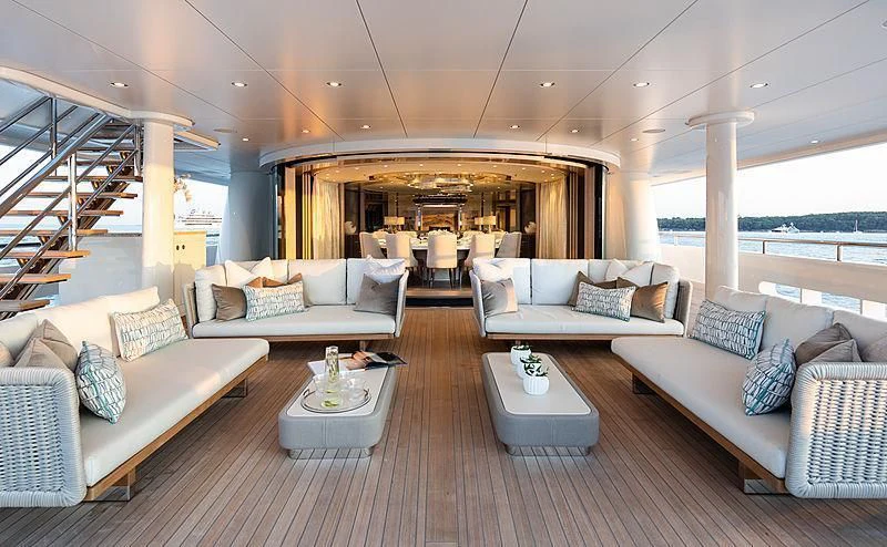 a living room with a large open staircase aboard NENINKA Yacht for Sale