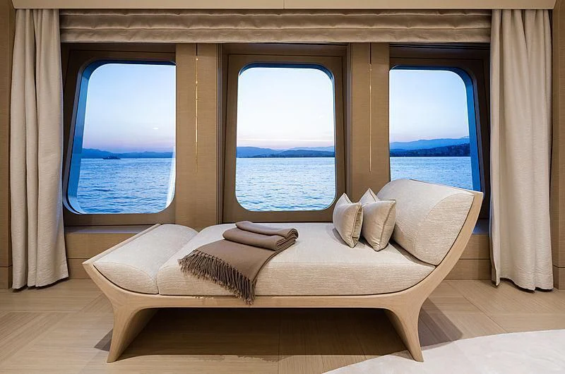a bed with a window aboard NENINKA Yacht for Sale