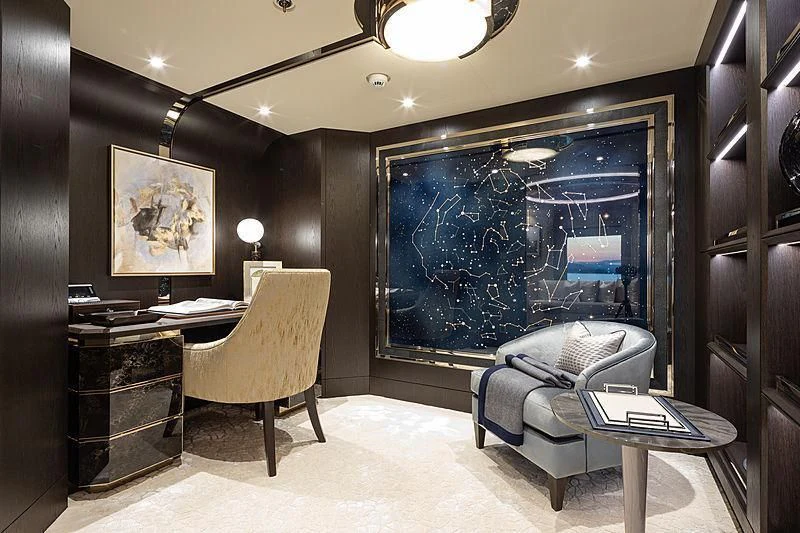 a room with a chair and a desk and a large screen aboard NENINKA Yacht for Sale