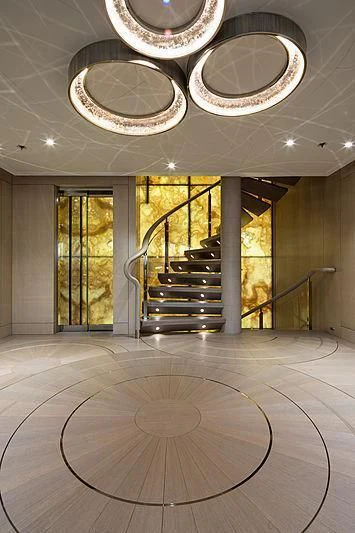 a large room with a staircase and chandelier aboard NENINKA Yacht for Sale