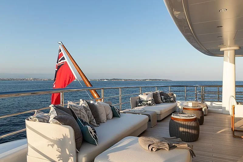 a boat with a flag on the deck aboard NENINKA Yacht for Sale