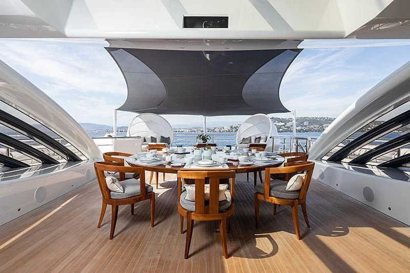 a boat with a table and chairs aboard NENINKA Yacht for Sale