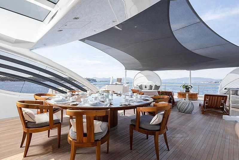 a table and chairs on a deck aboard NENINKA Yacht for Sale
