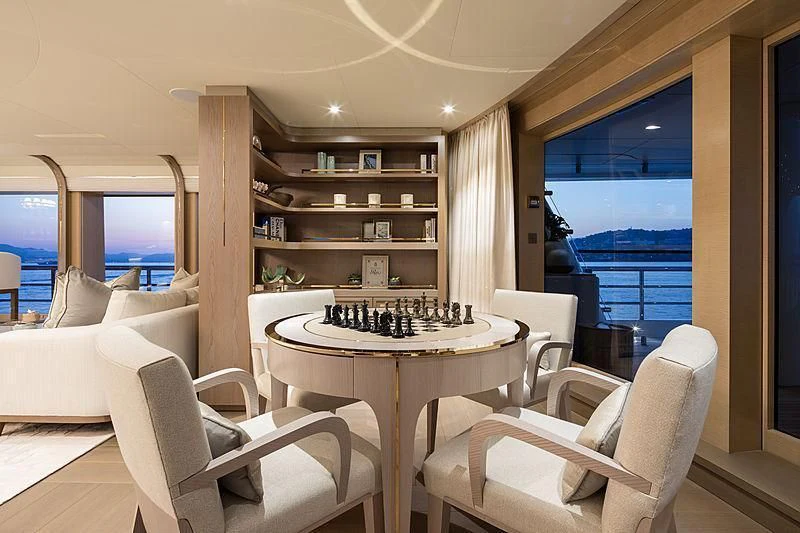 a room with a table chairs and a window aboard NENINKA Yacht for Sale
