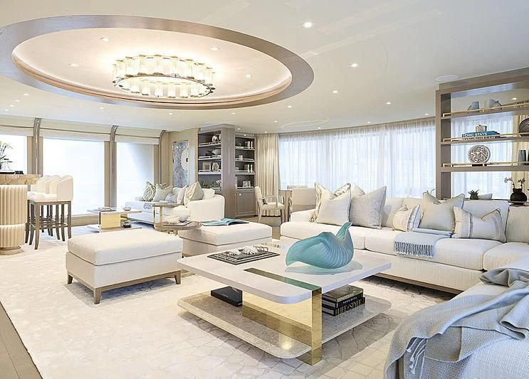 a living room with a large white sofa and a coffee table aboard NENINKA Yacht for Sale