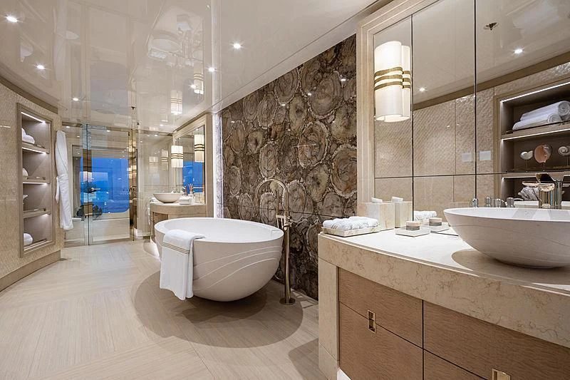 a bathroom with a large stone wall aboard NENINKA Yacht for Sale