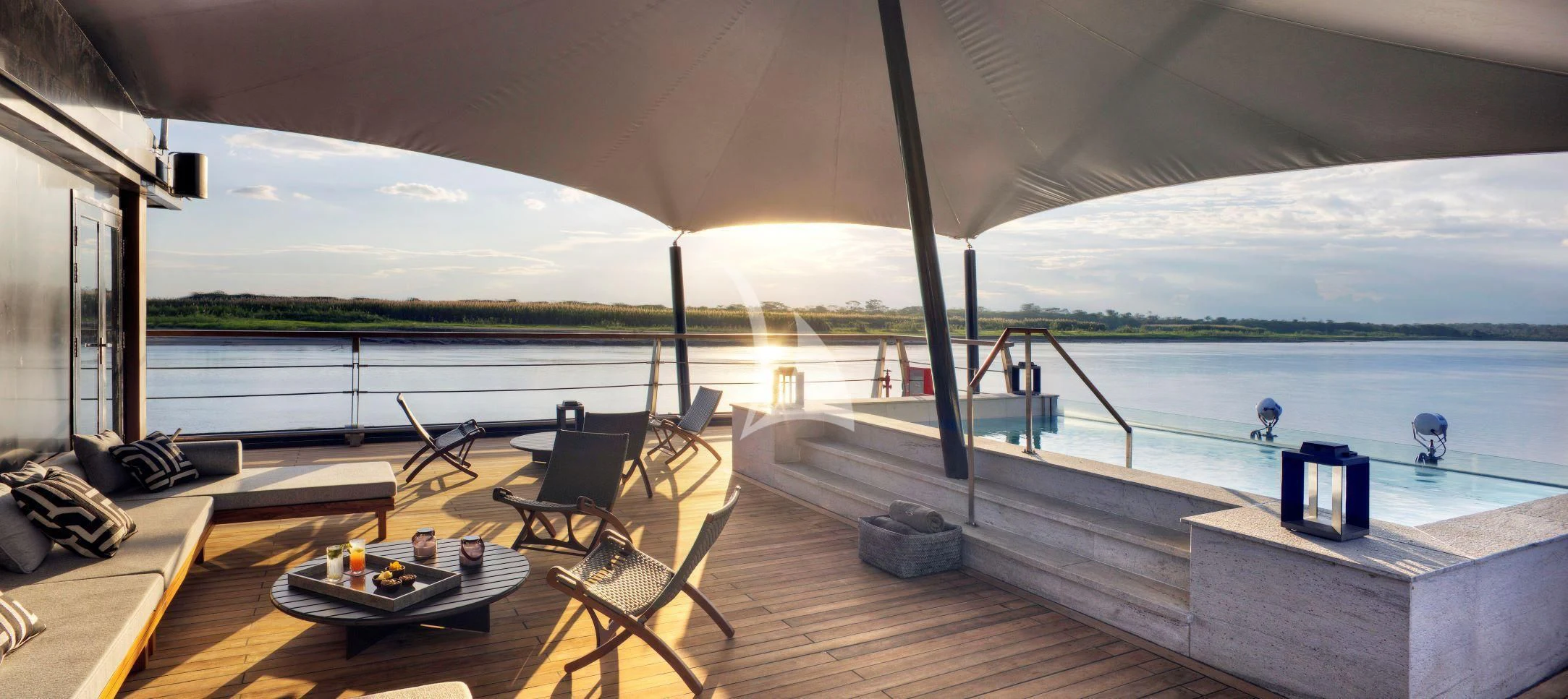 a deck with a table and chairs on it aboard AQUA NERA Yacht for Sale