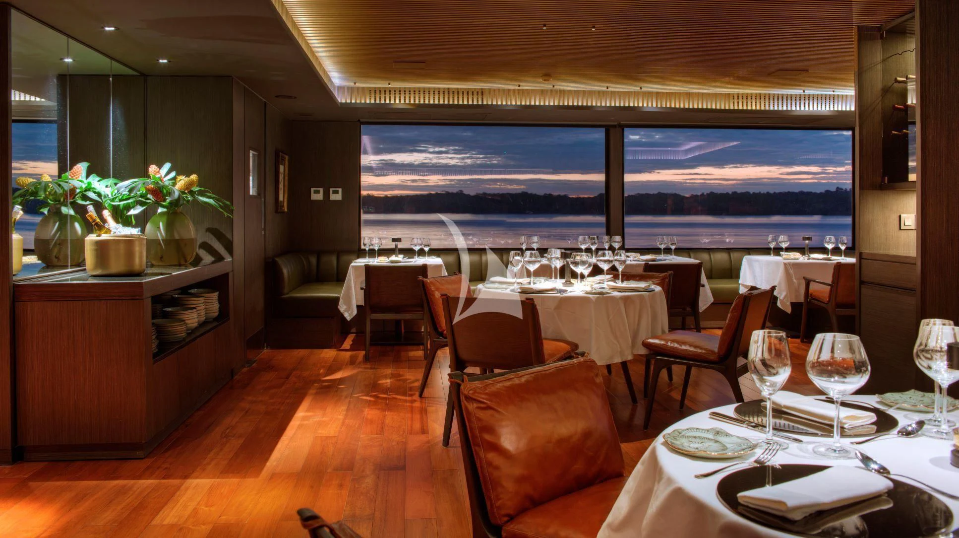 a room with tables and chairs aboard AQUA NERA Yacht for Sale