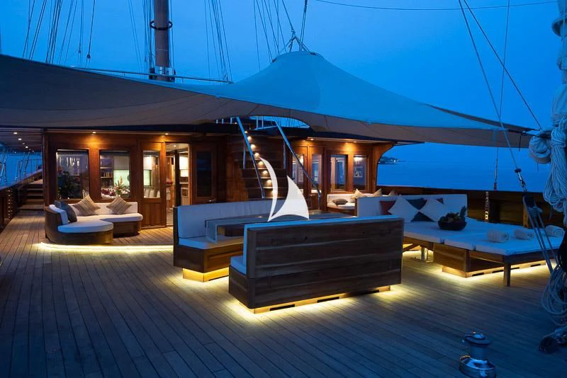 a large room with a bed and a table aboard LAMIMA Yacht for Sale