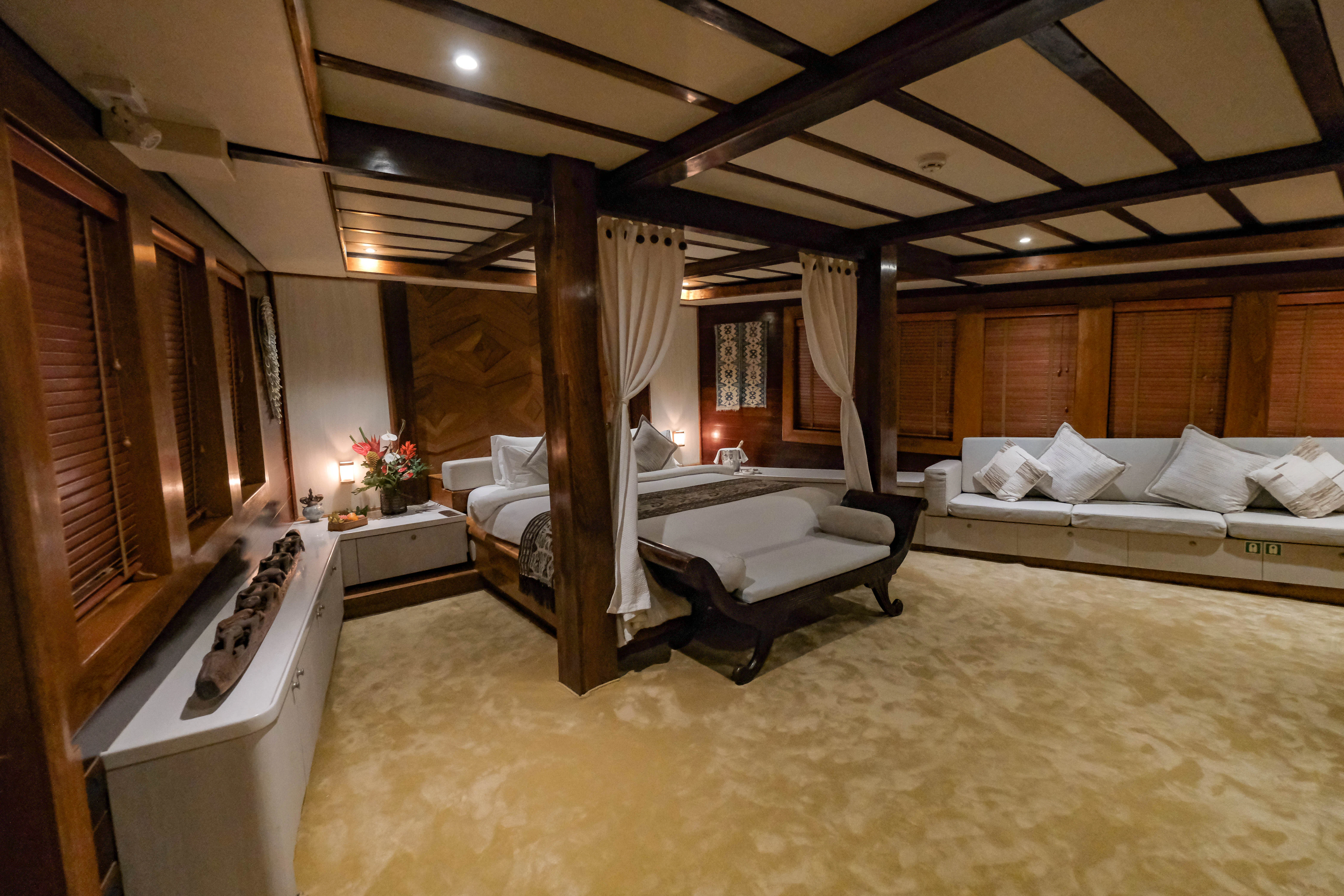 a large room with a bed and a desk aboard LAMIMA Yacht for Sale