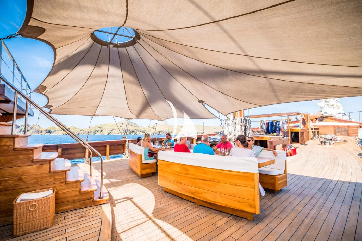 a group of people sitting under a tent aboard LAMIMA Yacht for Sale
