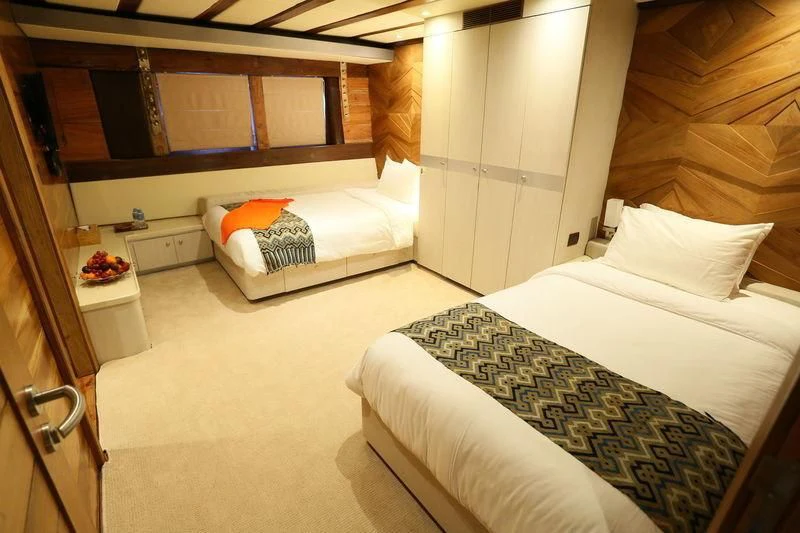 a room with two beds aboard LAMIMA Yacht for Sale