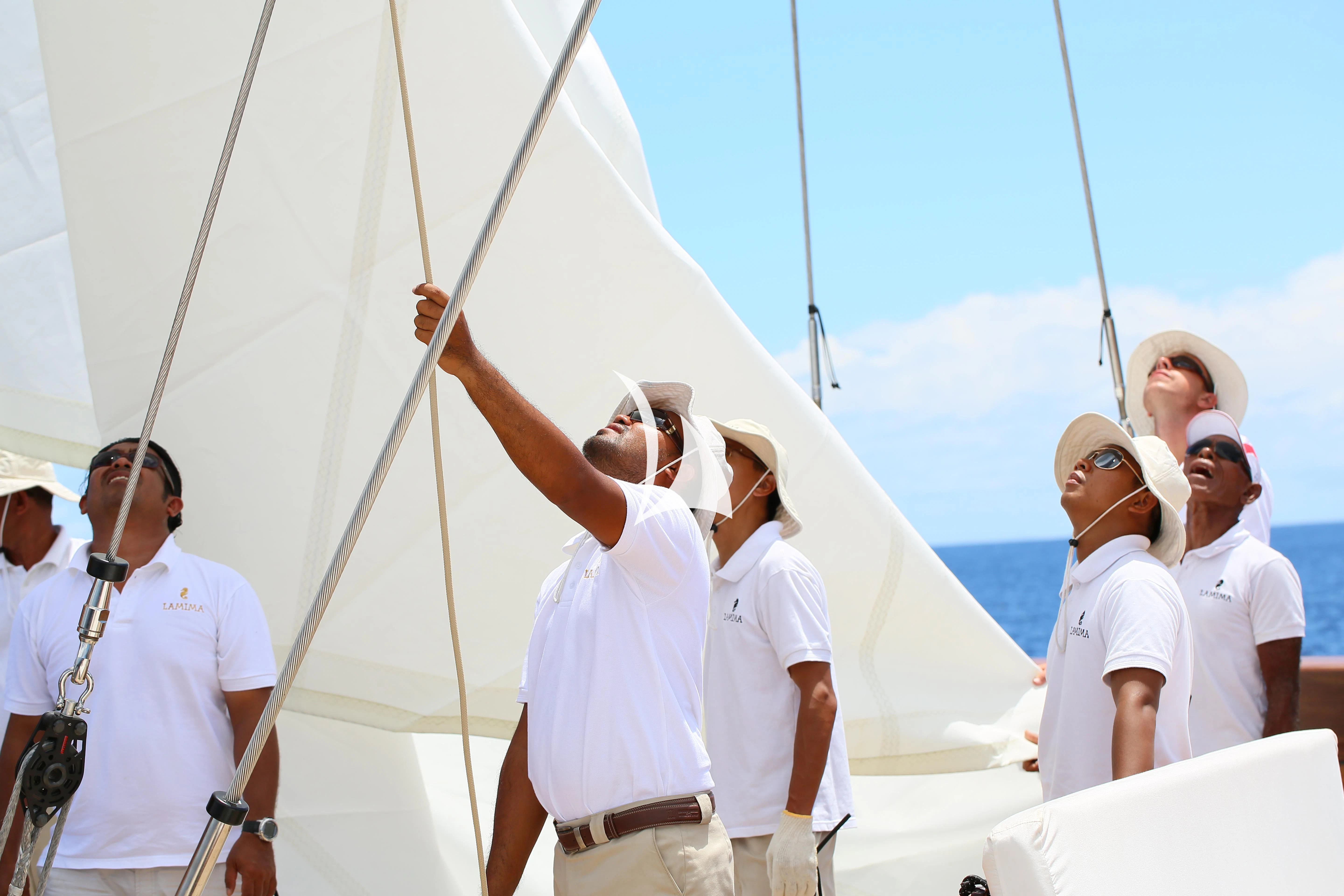 a group of people on a boat aboard LAMIMA Yacht for Sale