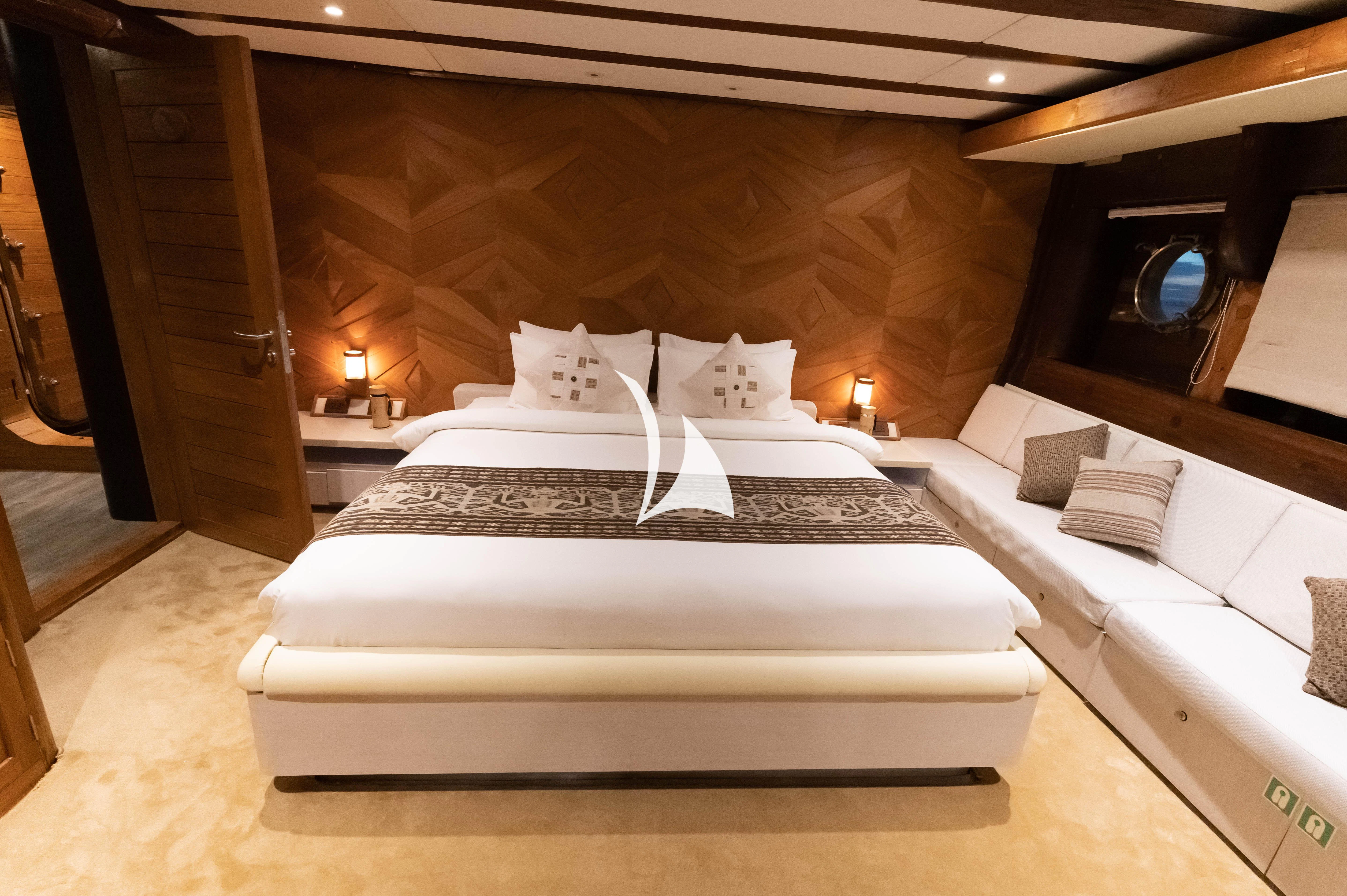 a bed with white sheets aboard LAMIMA Yacht for Sale