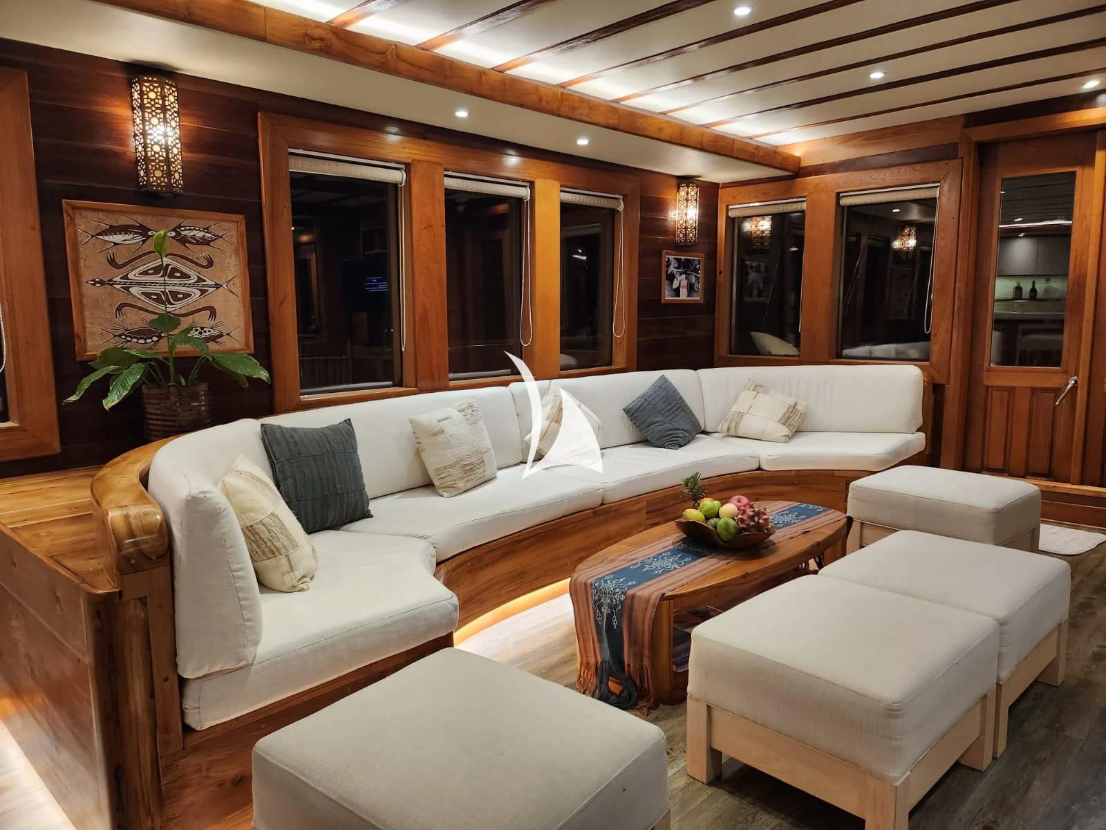 a living room with a couch and a table aboard LAMIMA Yacht for Sale