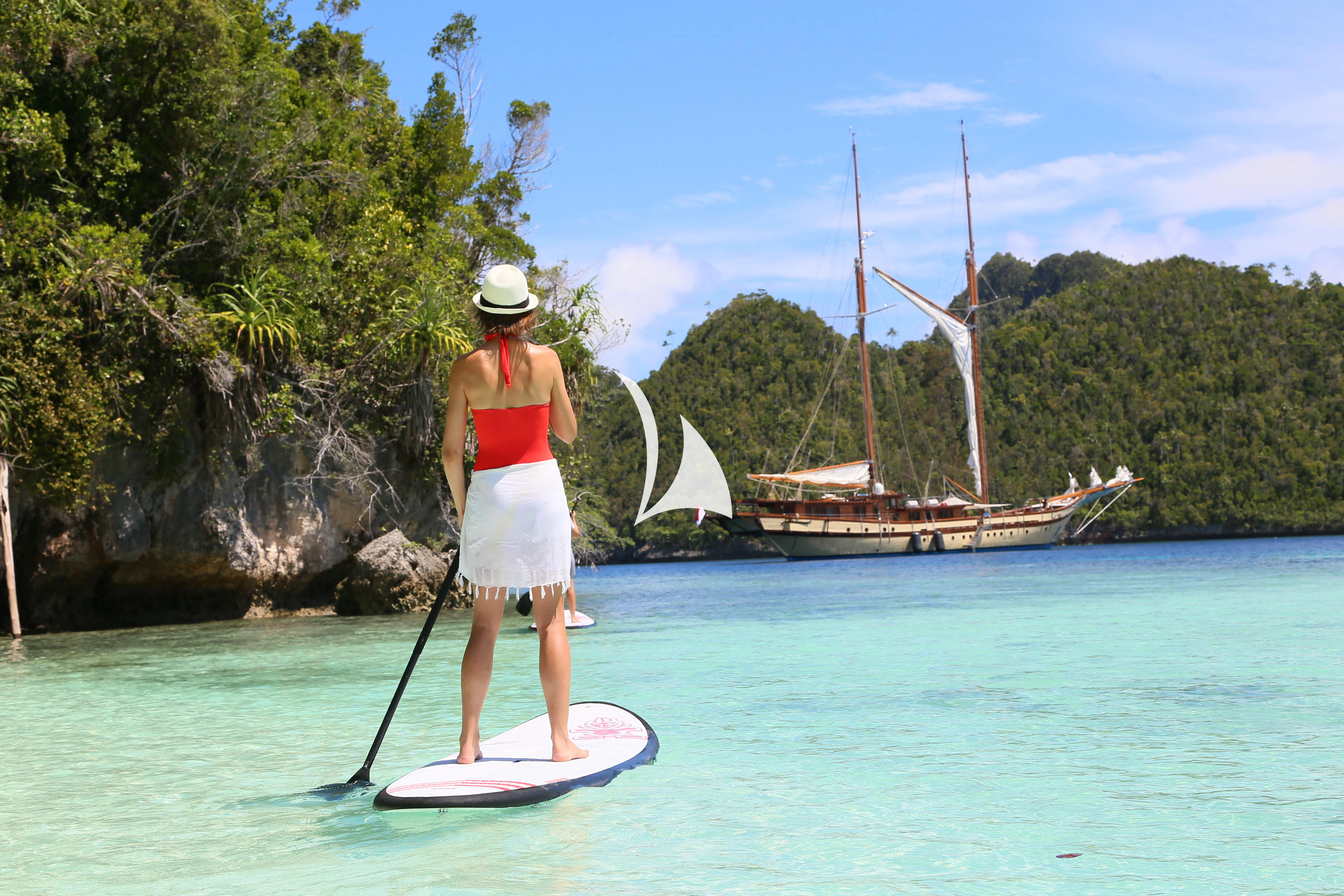 a person on a paddle board aboard LAMIMA Yacht for Sale