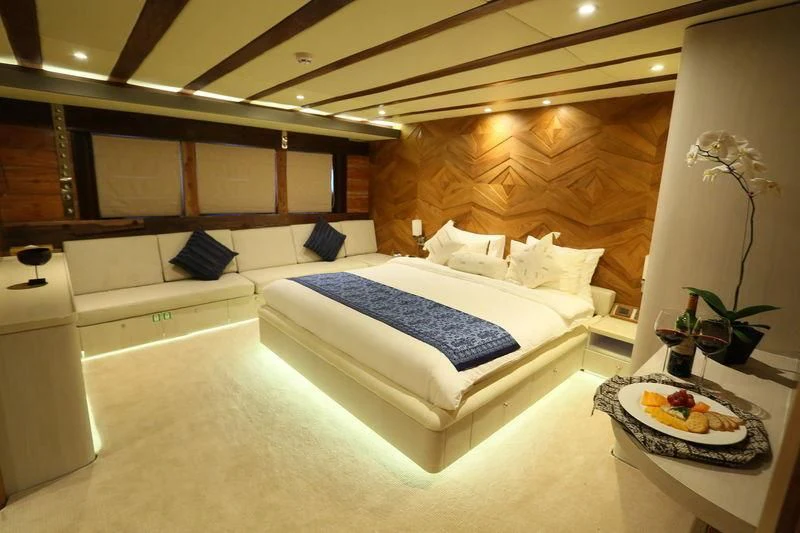 a bed with a white bed aboard LAMIMA Yacht for Sale