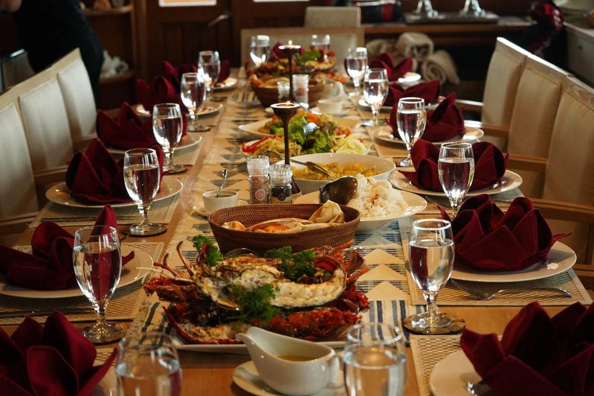 a table with food and wine aboard LAMIMA Yacht for Sale