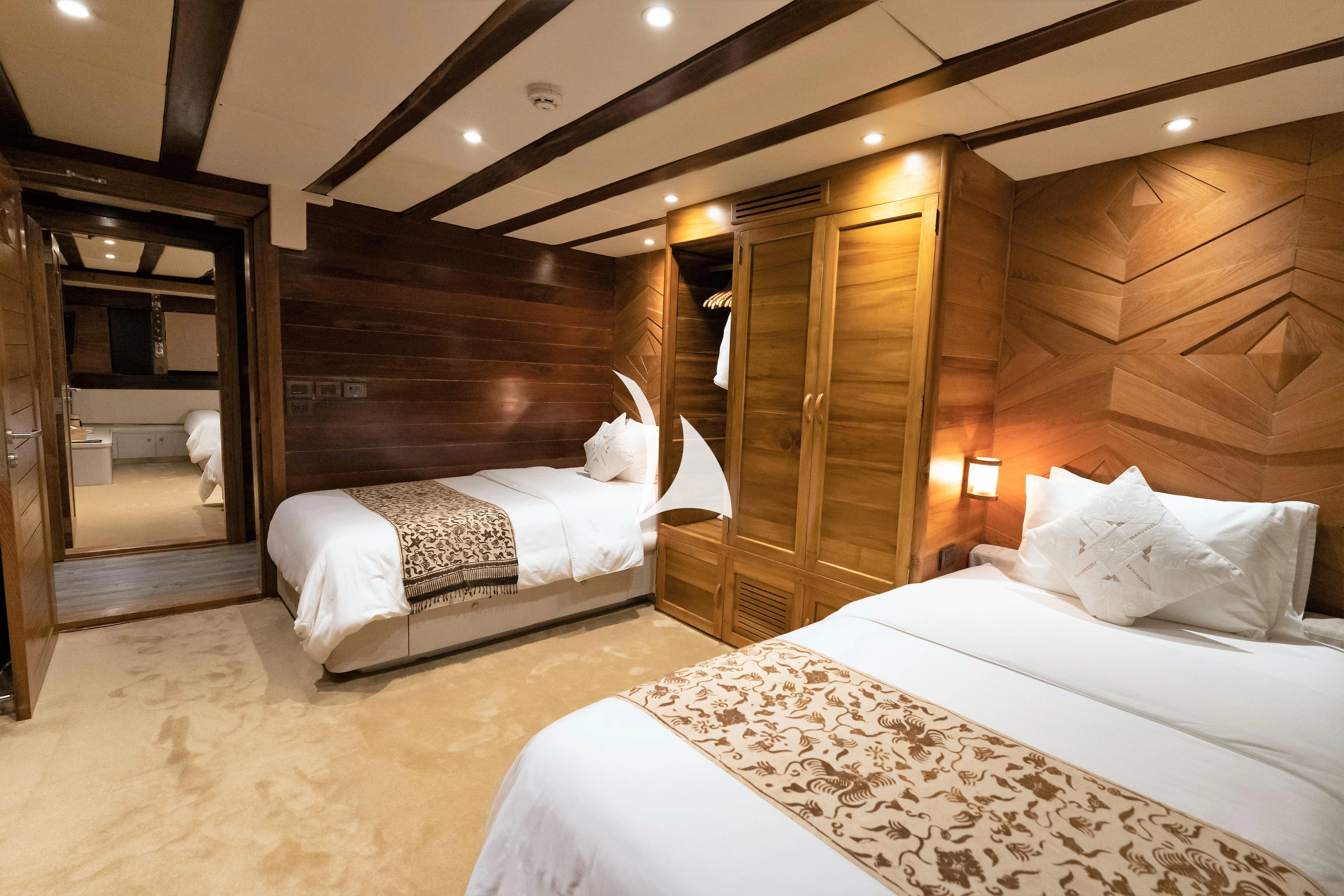 a room with a bed and a wood door aboard LAMIMA Yacht for Sale