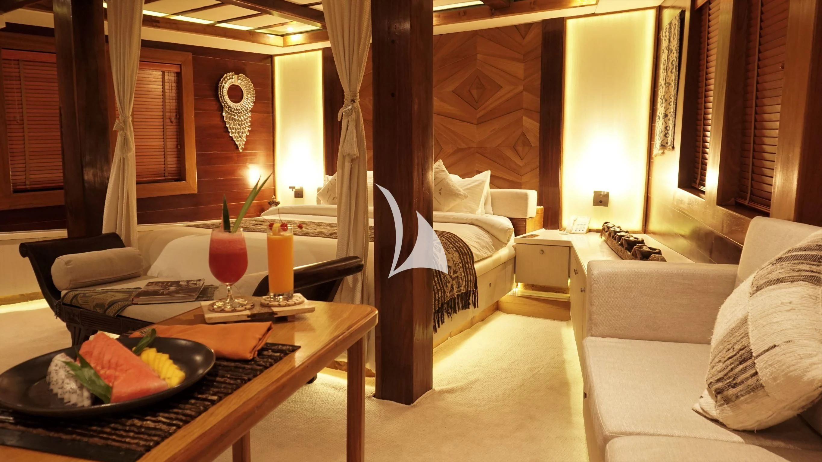 a room with a table and couch aboard LAMIMA Yacht for Sale