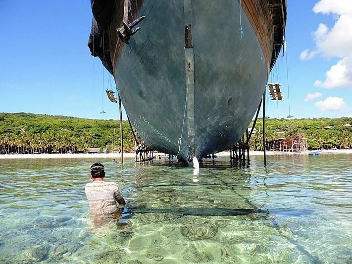 a person in a large pool of water with a large sailboat aboard LAMIMA Yacht for Sale