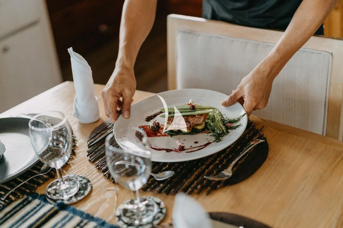 a person cutting a cake aboard LAMIMA Yacht for Sale