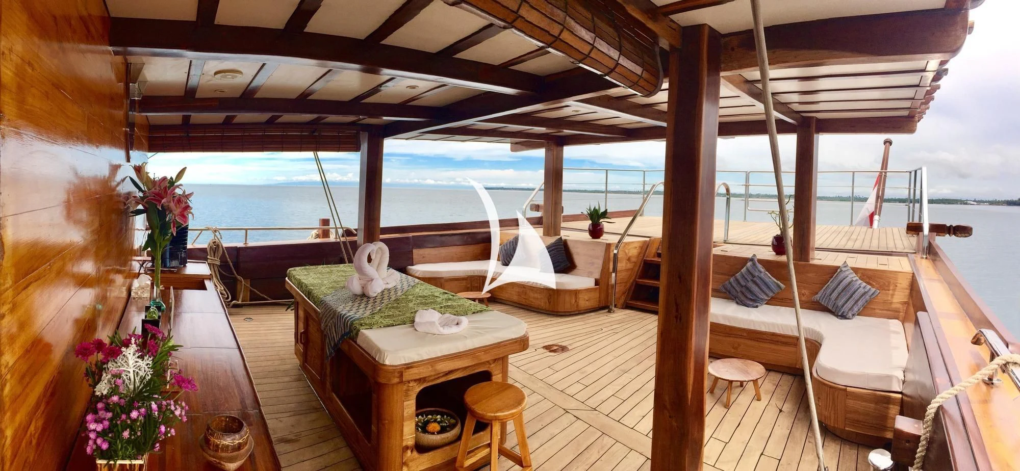 a room with a bed and a table and chairs aboard LAMIMA Yacht for Sale