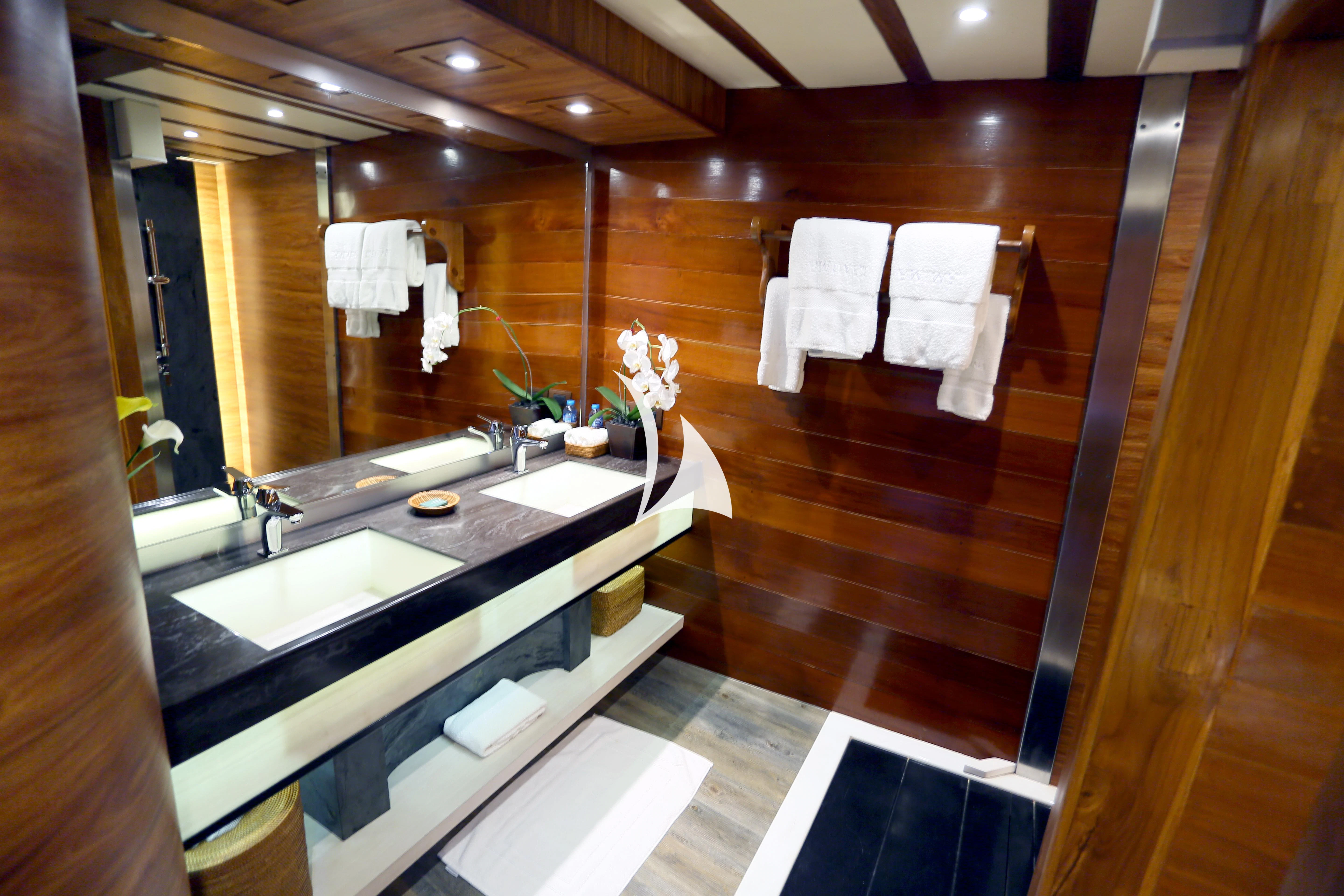 a bathroom with a large mirror aboard LAMIMA Yacht for Sale