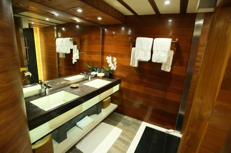 a bathroom with a large mirror aboard LAMIMA Yacht for Sale