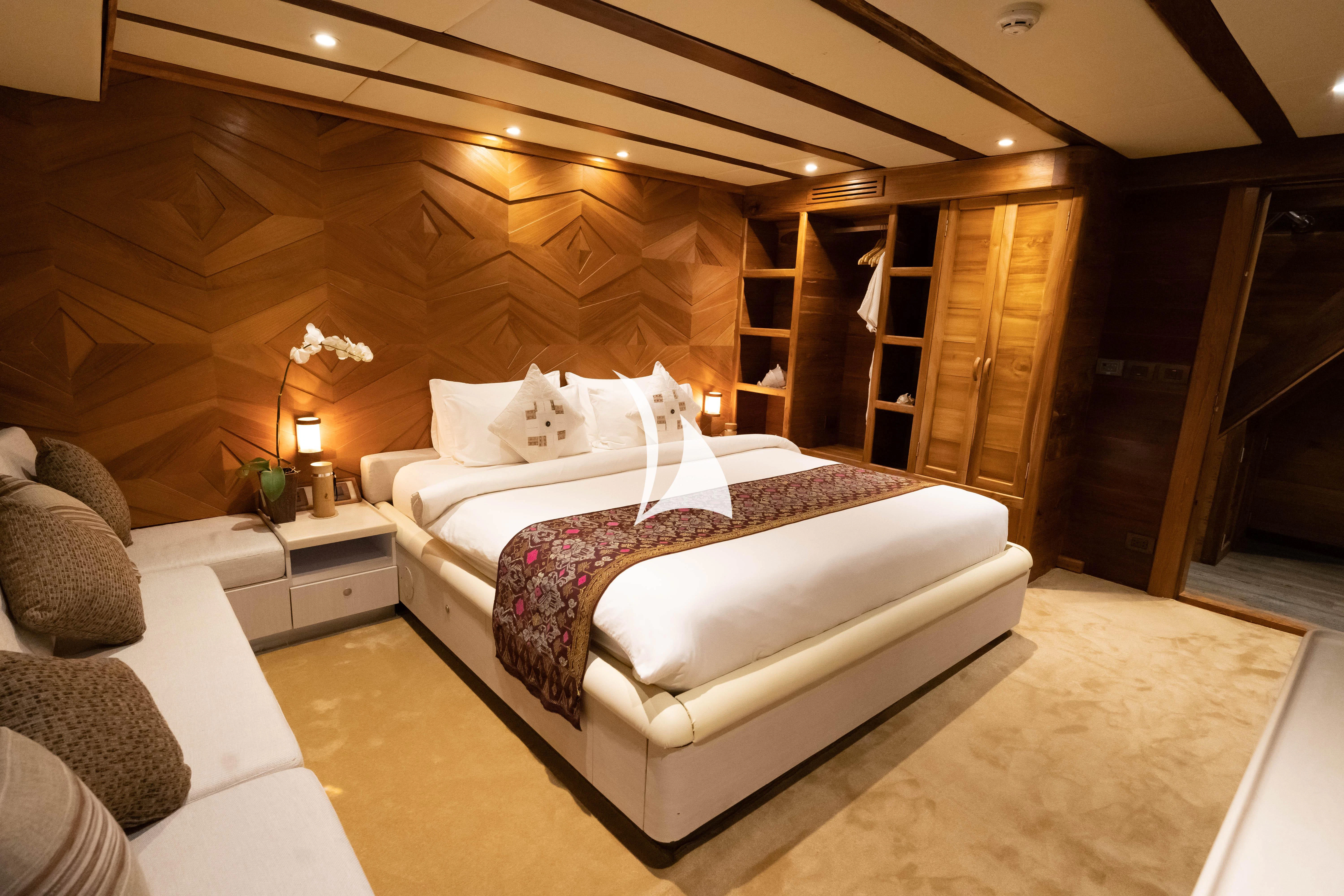 a room with a bed and a wood door aboard LAMIMA Yacht for Sale